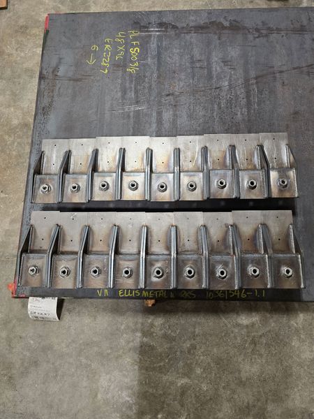 Metal fabrication parts are aligned on a worktable
