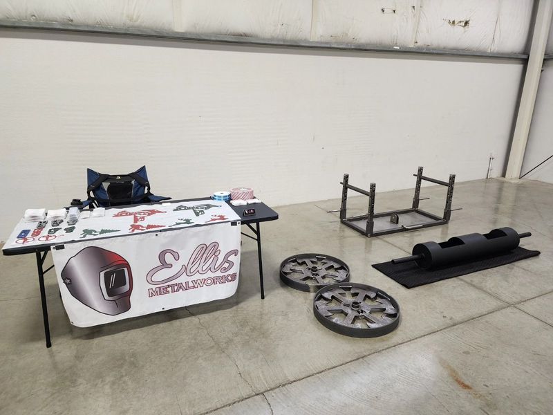 Ellis Metalworks booth features a display table with welding gear